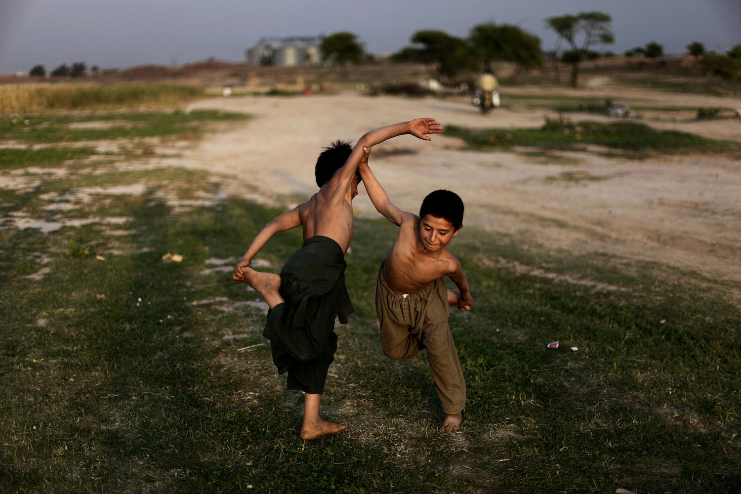 April 22, 2013. Afghan refugee boys, play a traditional fighting game, on the outskirts of Islamabad.