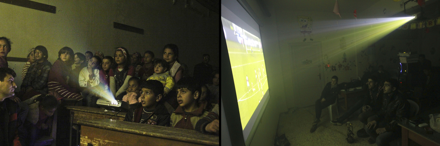 Internally displaced children watch cartoons in a classroom of a school in Kafranbel in Idlib