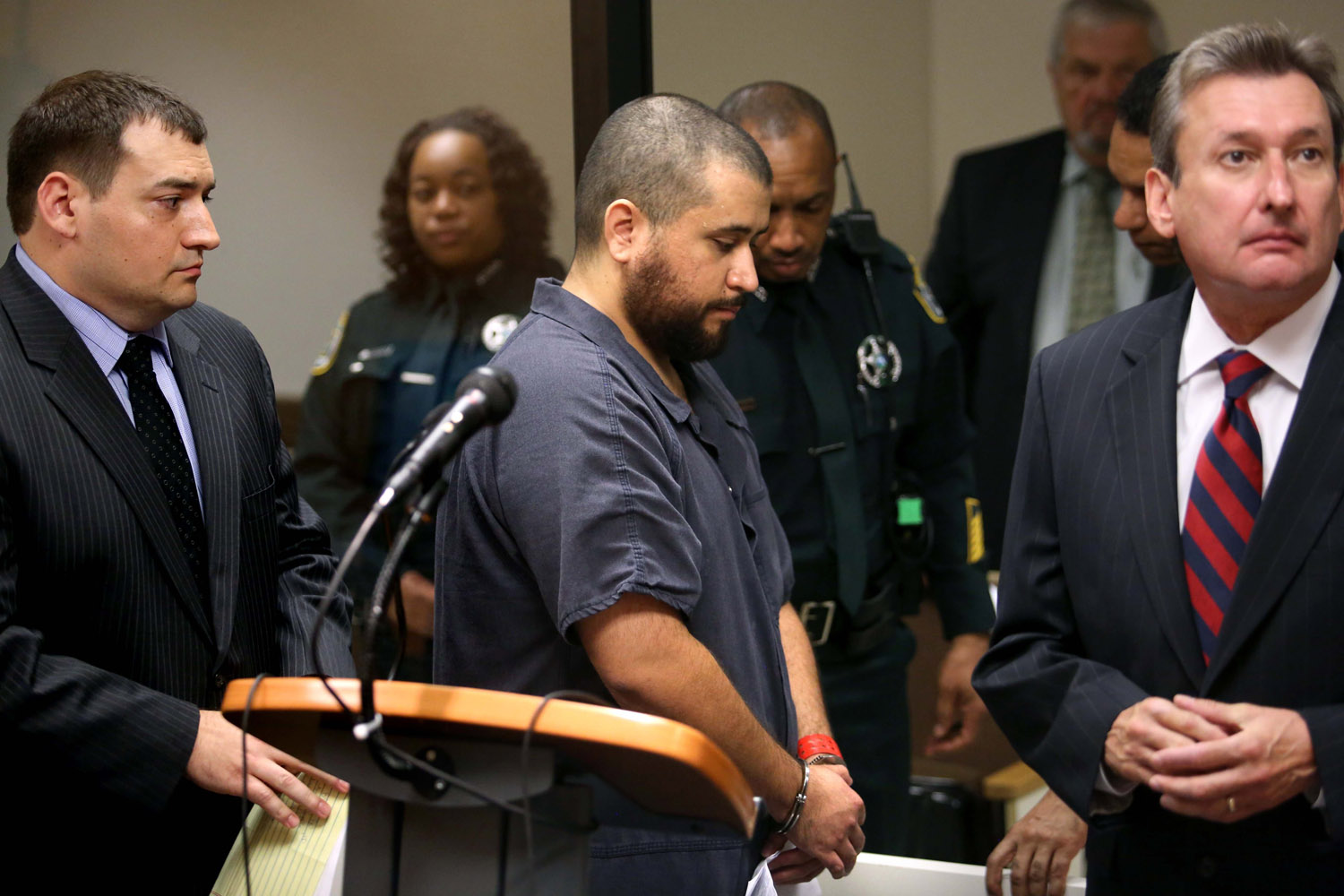 Nov. 19, 2013. George Zimmerman, the acquitted shooter in the death of Trayvon Martin, leaves Courtroom J2 with his defense counsel Daniel Megaro (left) and Jeff Dowdy after a first-appearance hearing on charges including aggravated assault stemming from a fight with his girlfriend in Sanford, Fla.
