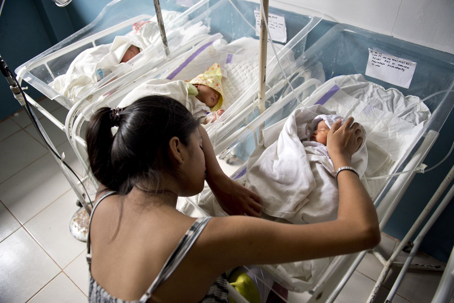 Nov. 20, 2013. The mother of premature baby Vothuan rests sitting by her cot in the children's and maternity ward at the Eastern Visayas Medical Centre in Tacloban, Philippines.