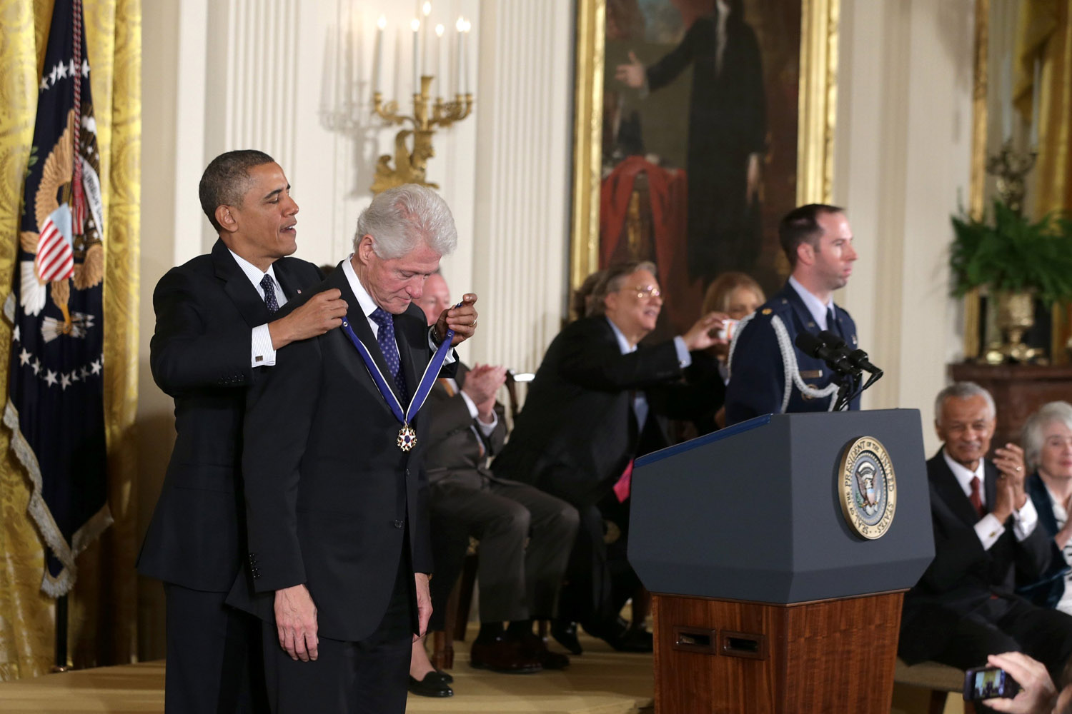 Nov. 20, 2013. U.S. President Barack Obama (L) awards the Presidential Medal of Freedom to former U.S. President Bill Clinton in the East Room at the White House in Washington.