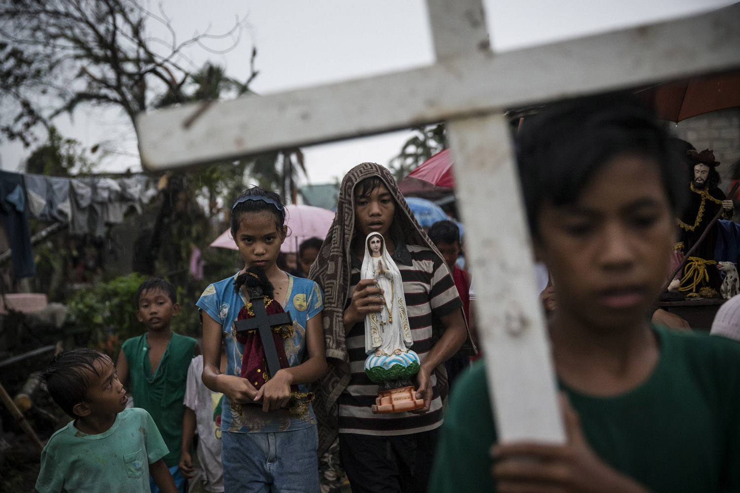 Nov. 22, 2013. Villagers carry religious statues during a procession before taking part in a Latin mass ceremony at a local Chapel in Santa Rita township in Eastern Samar, Philippines.