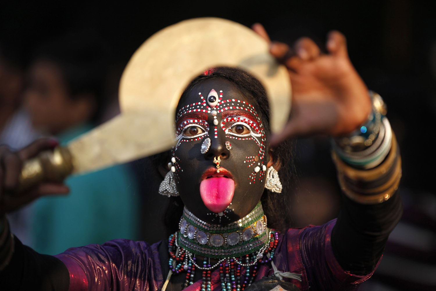 Nov. 20, 2013. A folk artist from India's northern Uttar Pradesh state performs during a procession held as part of the ongoing all India multilingual short play, folk dance competition and theater seminar in Allahabad, India.