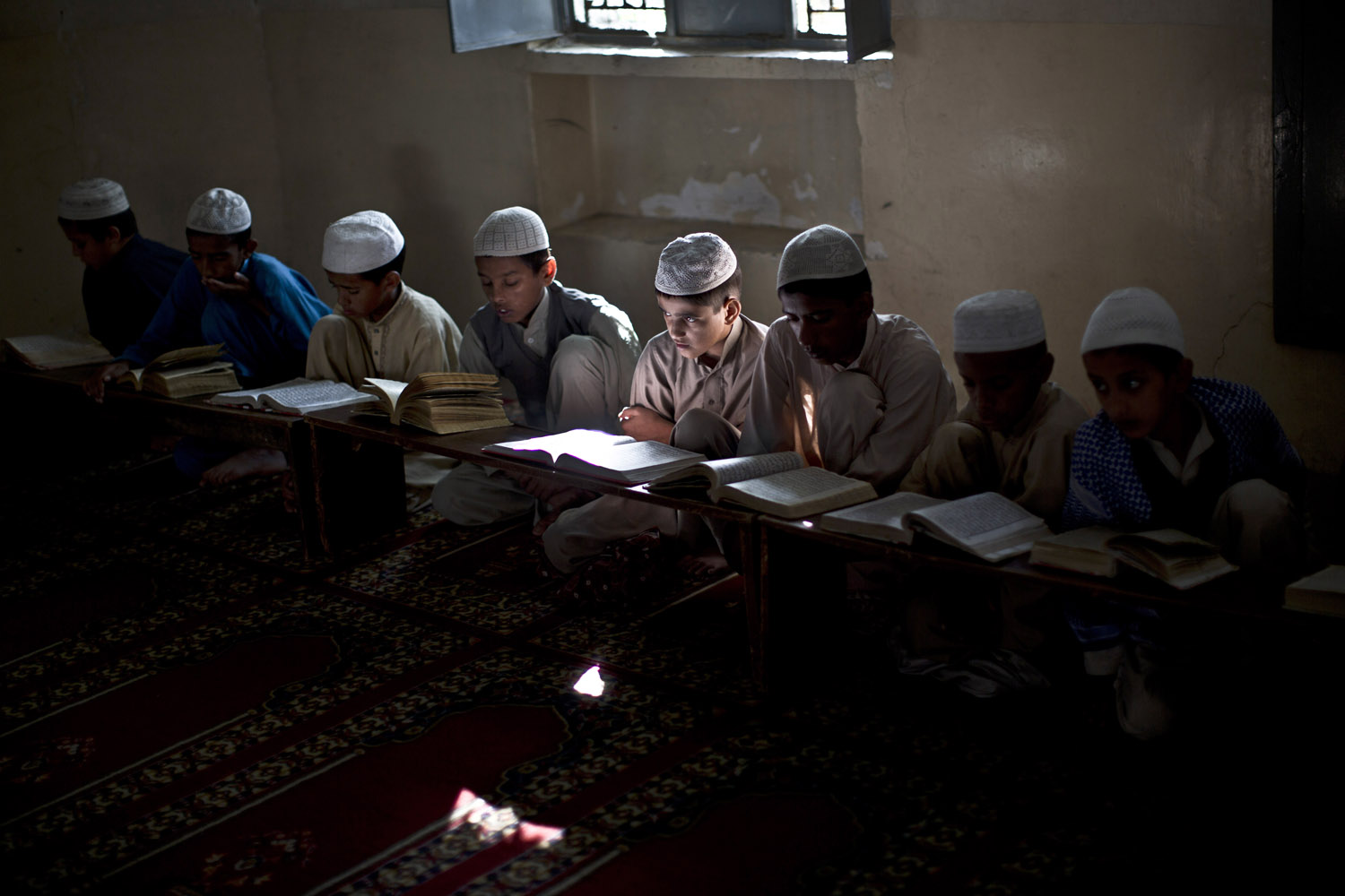 Oct. 28, 2013. Pakistani students of a Madrassa, or Islamic school, read verses of the Quran, at a mosque in Islamabad. Islamic schools form an important function within the Pakistan educational system.