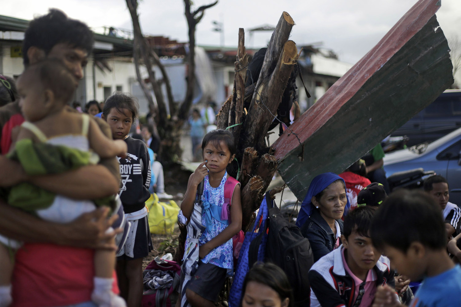 Nov. 21, 2013. Typhoon Haiyan survivors wait for their evacuation flights at the airport in Tacloban, Philippines.