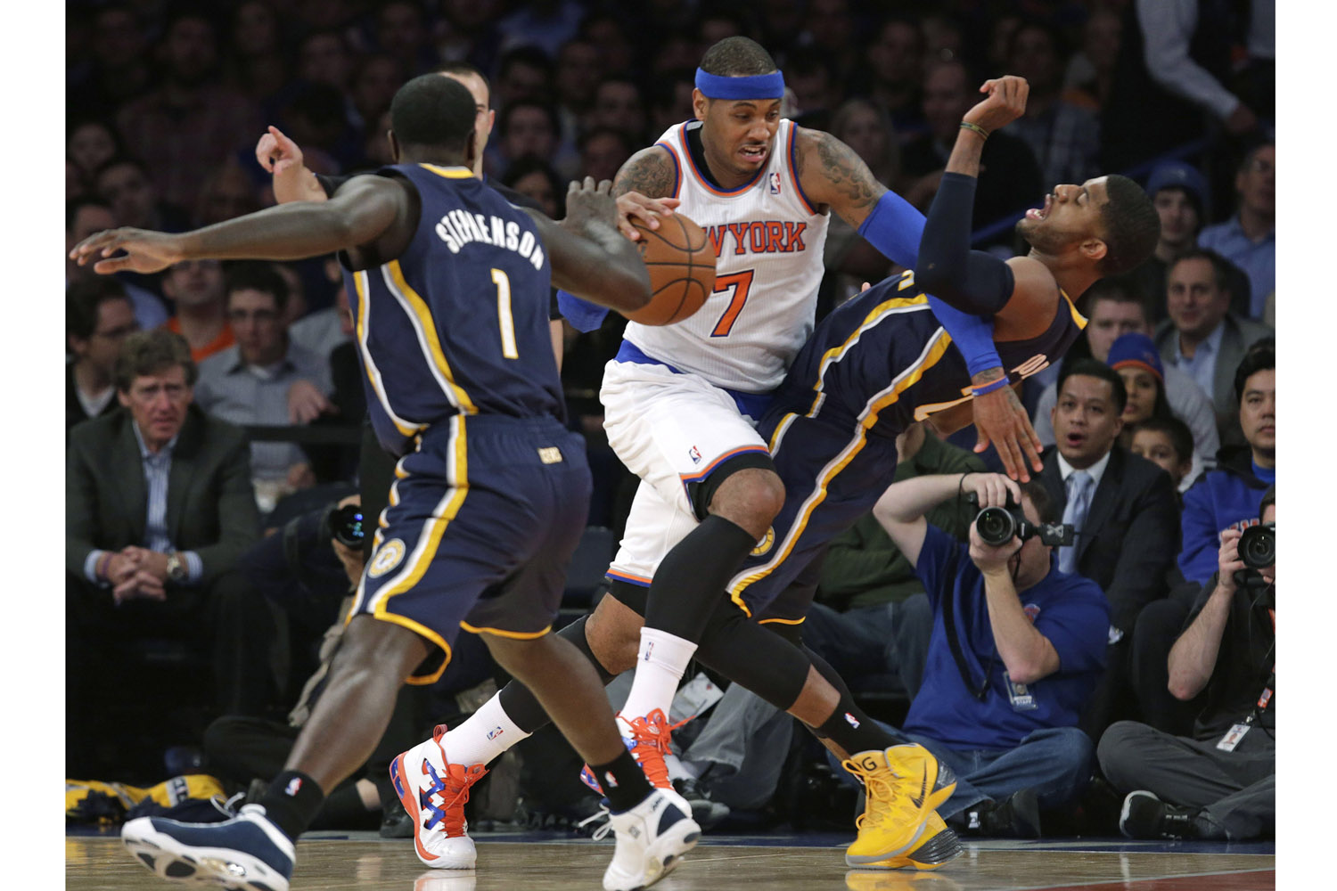 Nov. 20, 2013. New York Knicks small forward Carmelo Anthony (7) sends Indiana Pacers forward Paul George (24) to the floor in the first half of their NBA basketball game at Madison Square Garden in New York.