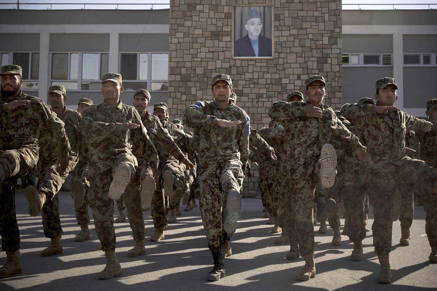 Nov. 26, 2013. Afghan Army soldiers exercise under a picture of Afghanistan's President Hamid Karzai at a training facility in the outskirts of Kabul.