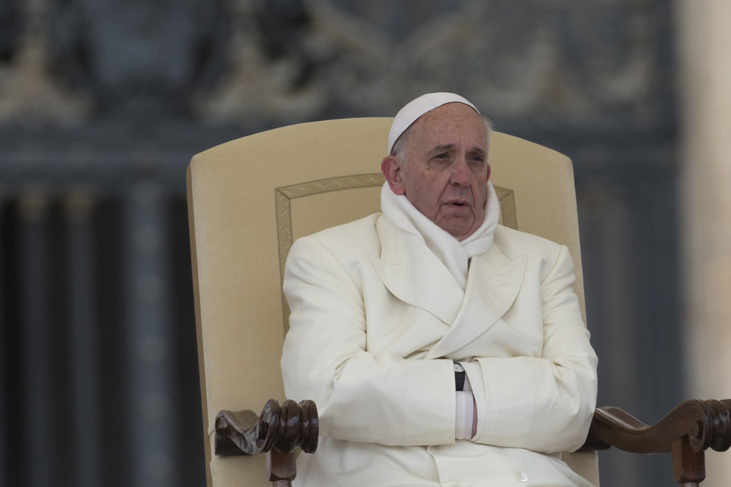 Nov. 27, 2013. Pope Francis tries to keep himself warm as he attends his weekly general audience in St. Peter's Square at the Vatican.