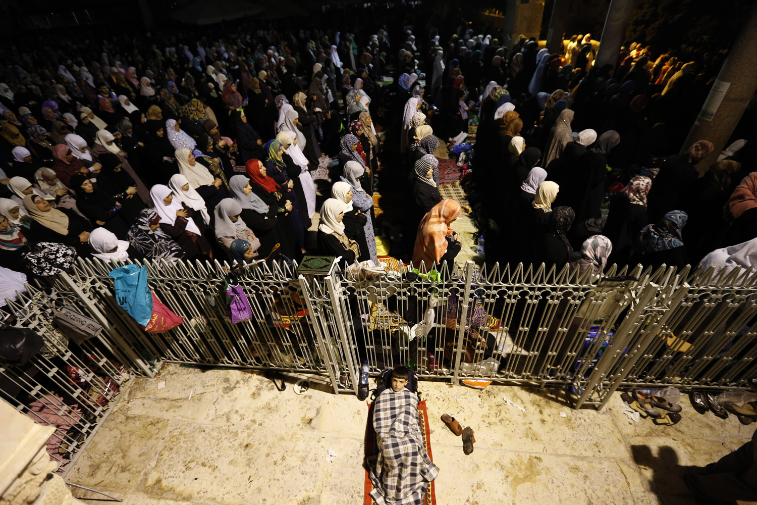 Female Palestinian worshippers pray in front of the Dome of the Rock, in the Al Aqsa Mosque compound in Jerusalem