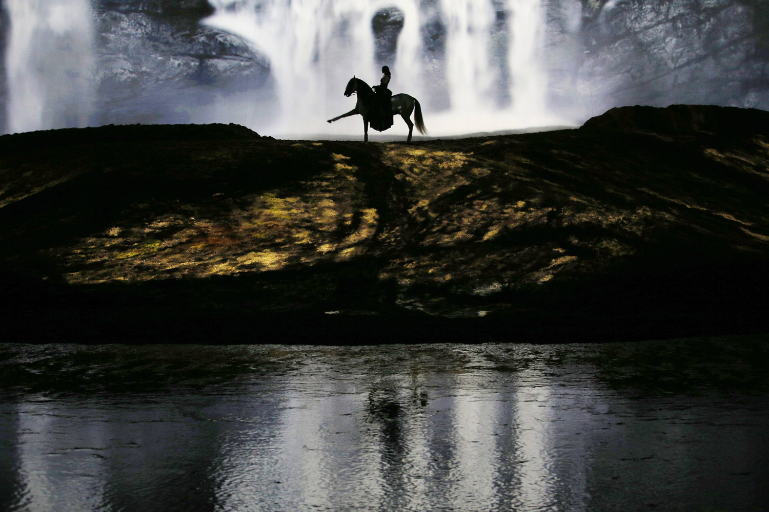 A horse and rider perform during a "sneak peek" performance of Cavalia's show "Odysseo" in Somerville