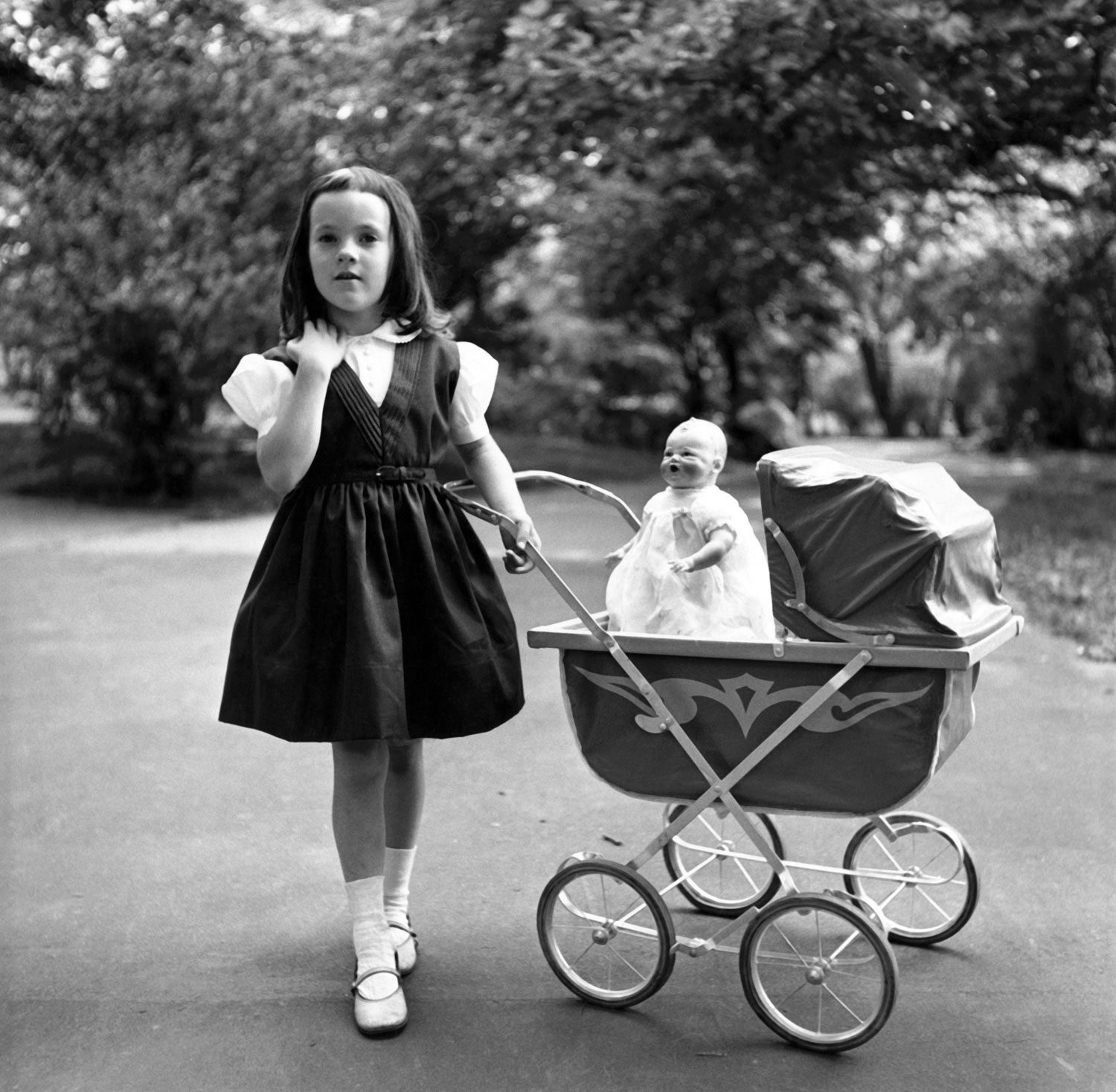Kathy Slate with doll in baby carriage, circa 1953.
