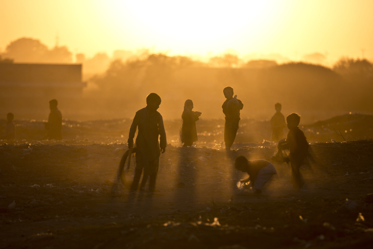 Nov. 25, 2013. Afghan refugee children play in a field as the sun sets on the outskirts of Islamabad, Pakistan.