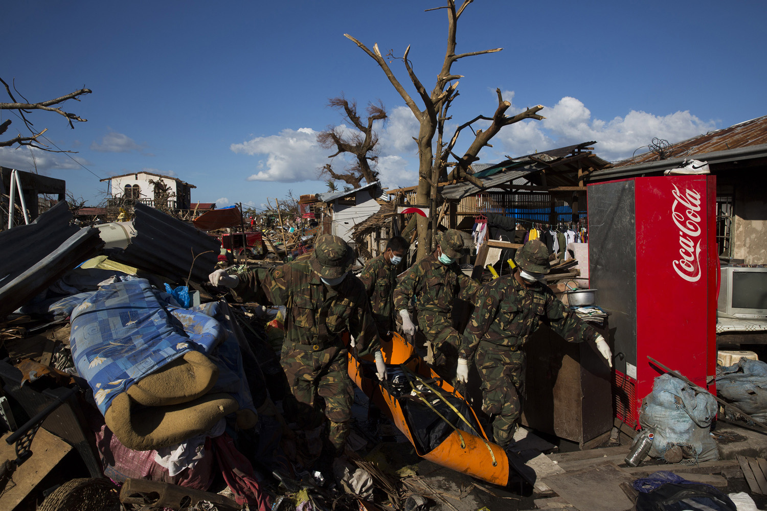 Soldiers joined search and rescue teams collecting bodies of victims in Tanuan, The Philippines on Nov. 15, 2013.