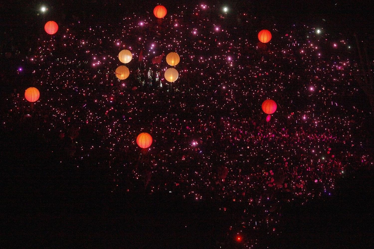 People with LED lights take part in forming a giant pink dot in Singapore