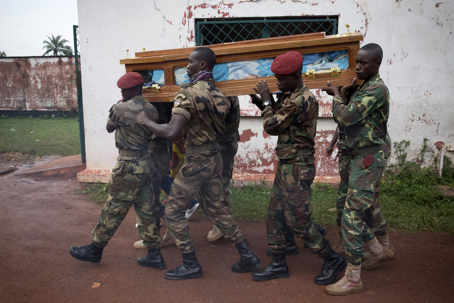CAR army soldiers carry the body of a colleague assassinated by members of the Seleka . The man, Tanguy Residou, was a nephew of the president Bozizé. Murders and others exactions made by the Seleka are increasing in the country. Bangui.