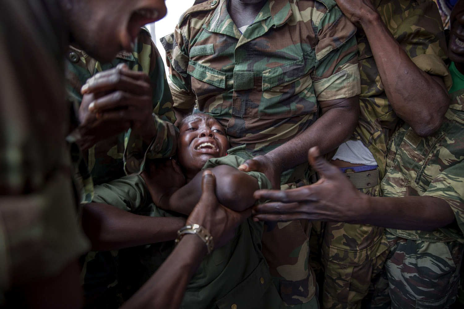 Army soldiers cry the death of colleague Tanguy Residou, who was shot dead by Seleka members. The man as a nephew of former president Bozizé. Bangui.