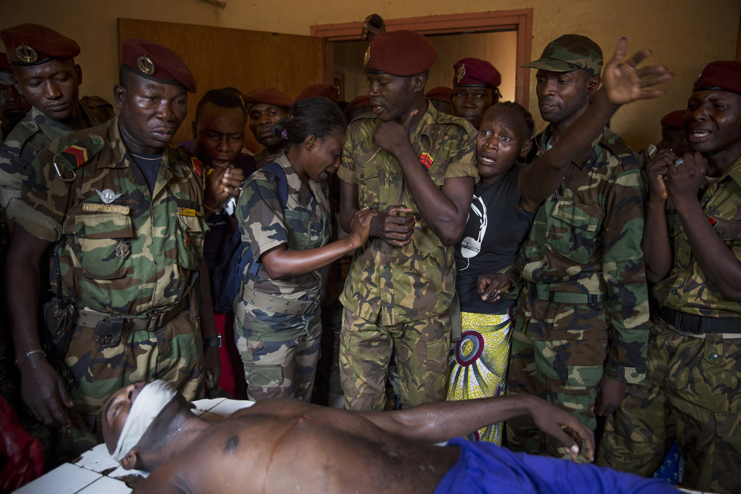 Army soldiers cry the death of colleague who was shot dead by Seleka members the night before. Bangui.