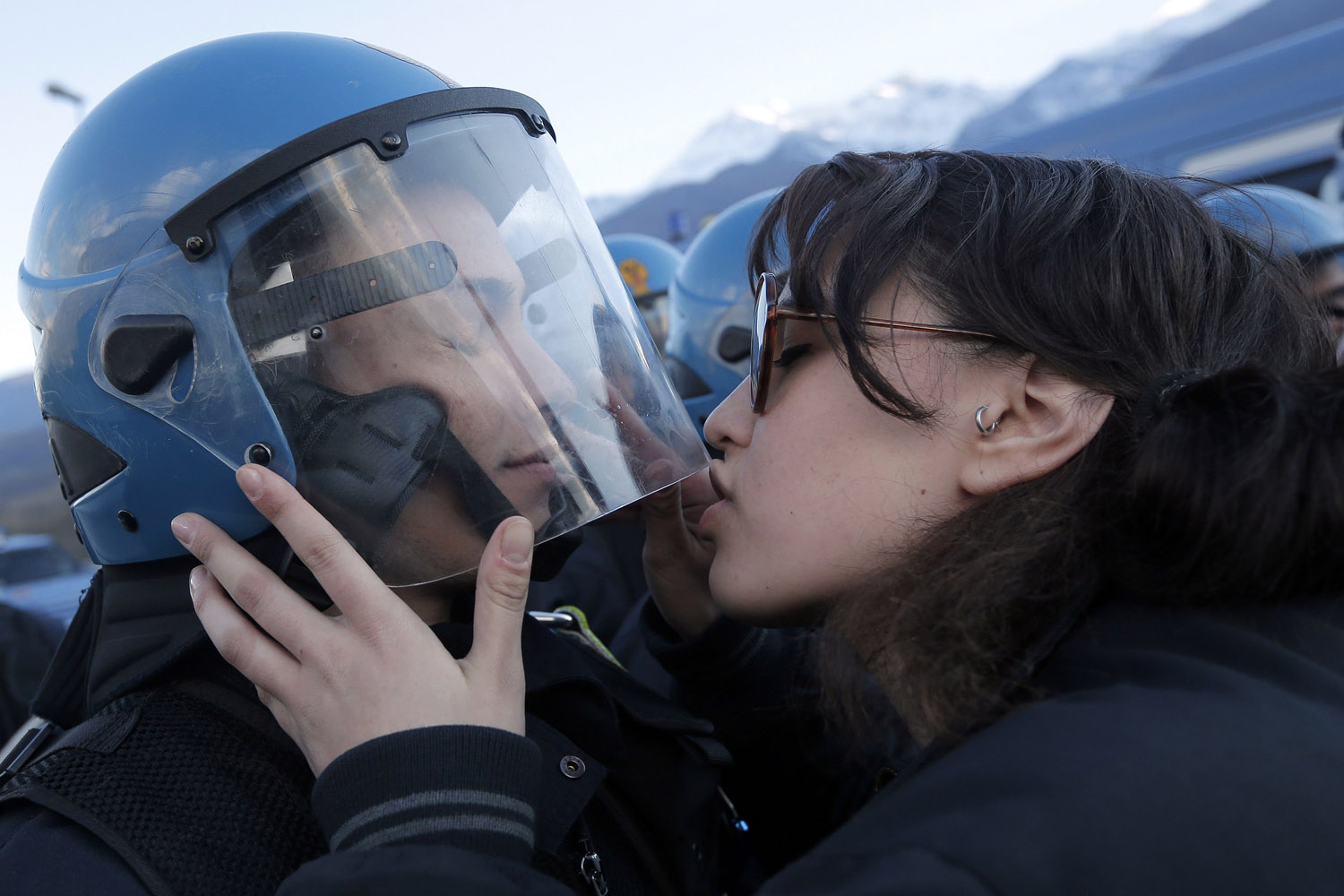 Nov. 16, 2013. A demonstrator kisses a riot police officer during a protest in Susa, Italy against the high-speed train (TAV in Italian) line between Lyon and Turin.