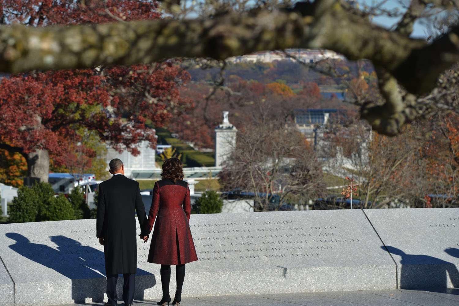 Nov. 20, 2013. U.S. President Barack Obama and First Lady Michelle Obama read an inscription after taking part in a wreath-laying ceremony in honor of the late U.S. President John F. Kennedy at Arlington National Cemetery in Arlington, Virginia.