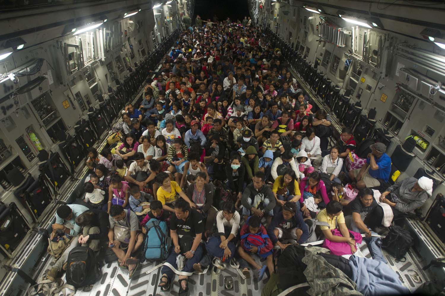 Nov. 22, 2013. In this image released by the U.S. Navy, Tacloban residents displaced by Typhoon Haiyan fill the cargo hold of a C-17 Globemaster military cargo plane.
