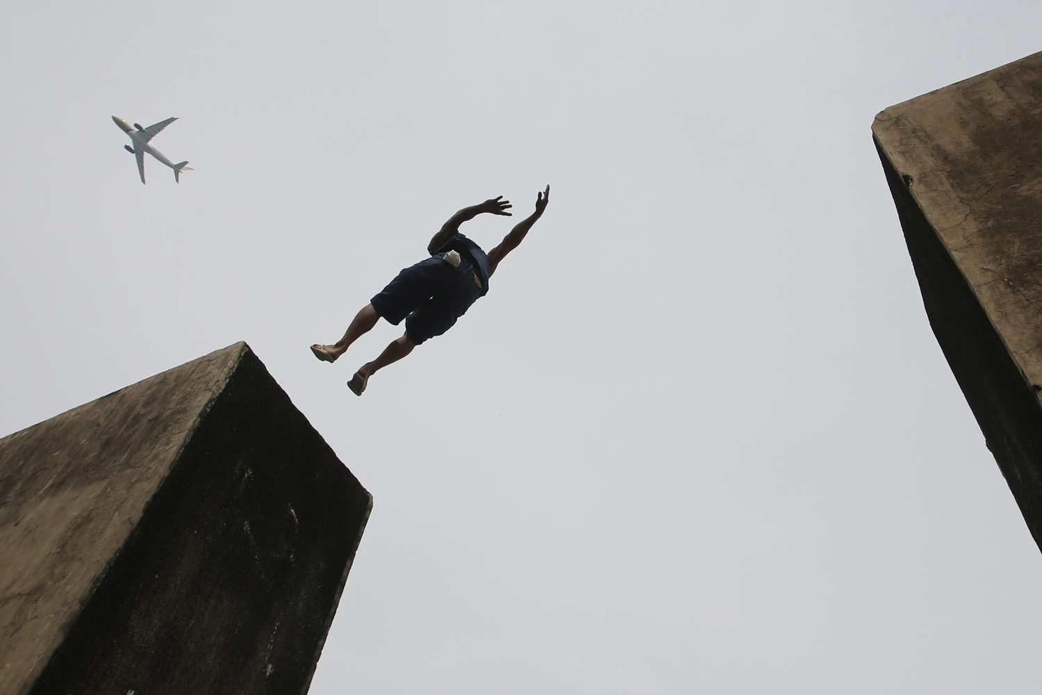 Oct. 31, 2013.  A Filipino boy jumps between apartment type tombs at a public cemetery in Paranaque city, south of Manila, Philippines.