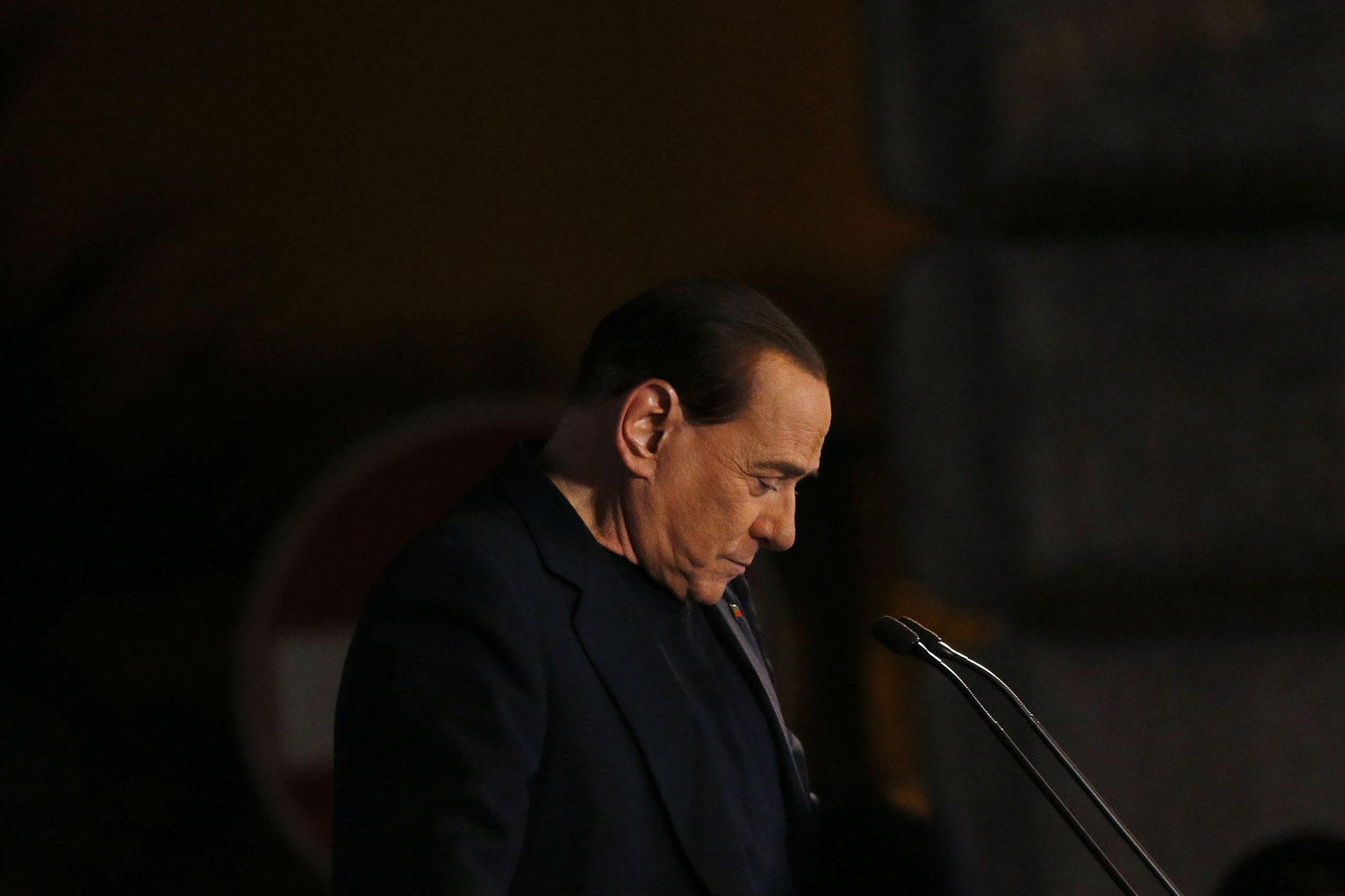 Former Prime Minister Silvio Berlusconi delivers a speech from the stage in downtown Rome