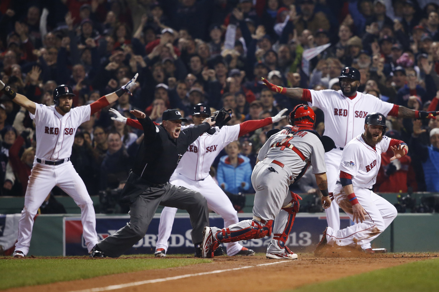 Oct. 30, 2013. St. Louis Cardinals catcher Yadier Molina looks back as home plate umpire Jim Joyce calls Boston Red Sox's Jonny Gomes safe on a three-run double by Shane Victorino during the third inning of Game 6 of the World Series in Boston.