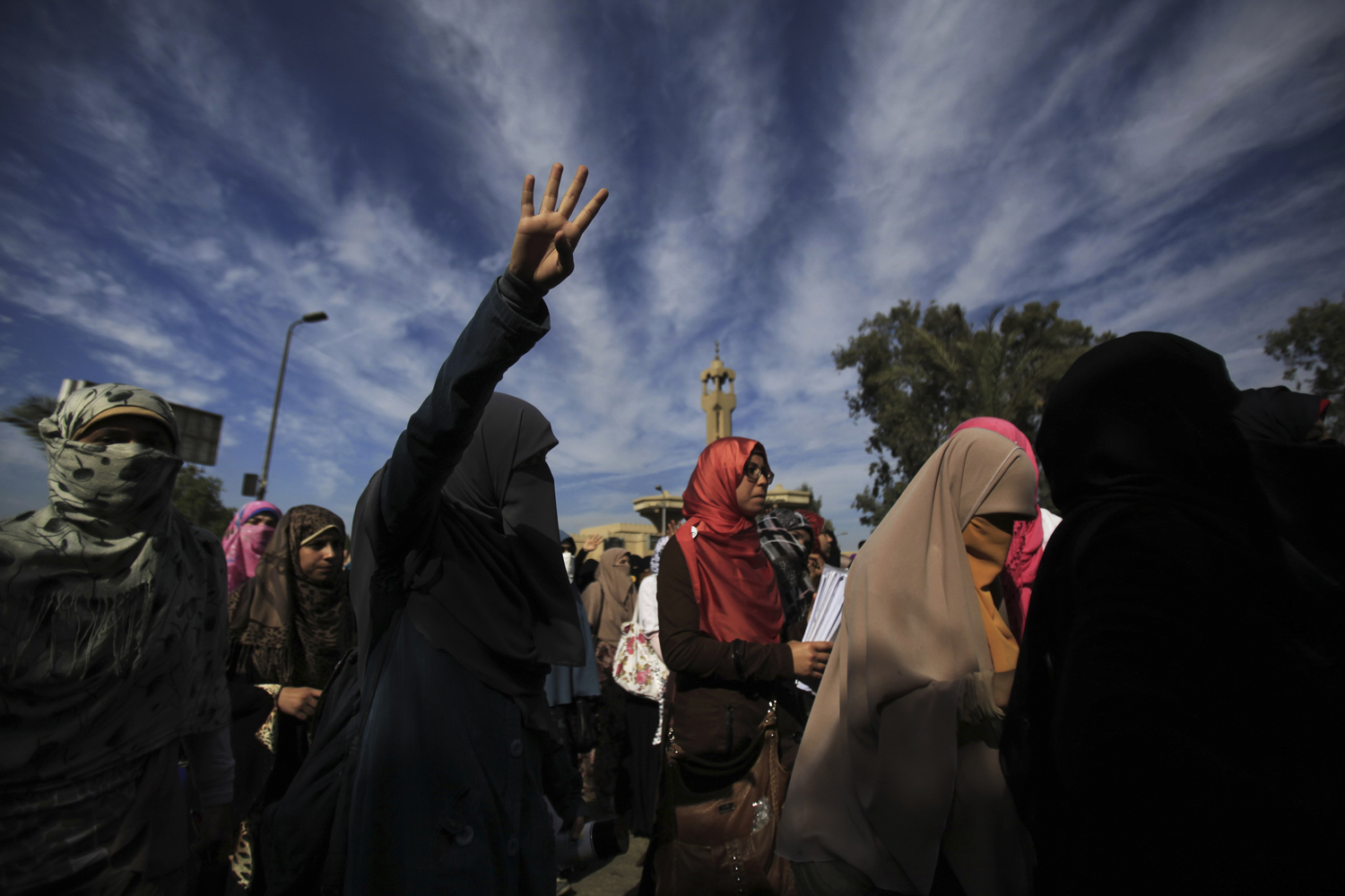 Nov.  21, 2013. Female students of Al-Azhar University, supporters of the Muslim Brotherhood and ousted Egyptian President Mohamed Mursi, shout slogans against the military and interior ministry while gesturing with four fingers after last night's clashes as they block Moustafa Al Nahas street in front of Al-Azhar University Campus at Cairo's Nasr City district.