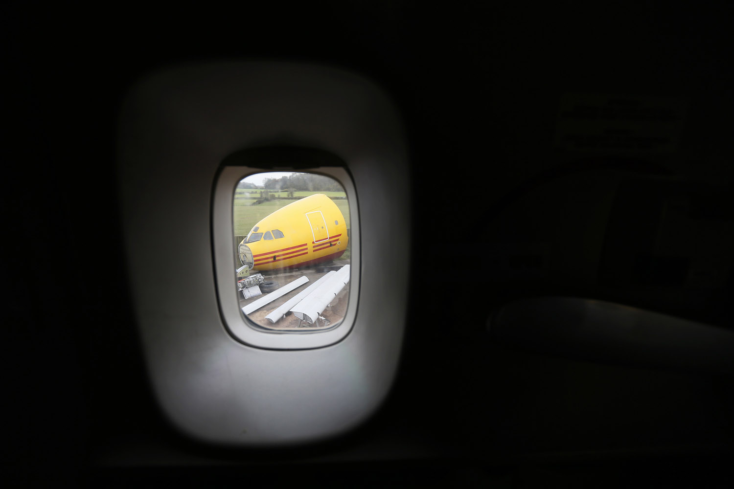 A dismantled Airbus A300 is seen through a window of a Boeing 747 in the recycling yard of Air Salvage International (ASI) in Kemble