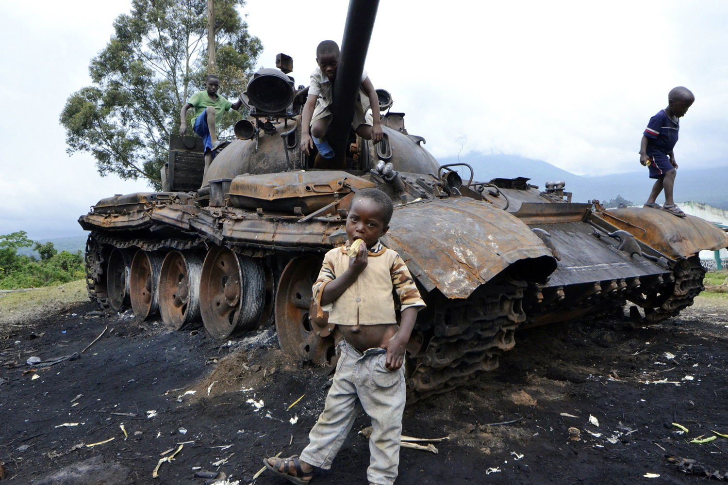 Oct. 31, 2013. 
                              Children play on a burned tank which formerly belonged to M23 rebel soldiers, in Kimbumba, Democratic Republic of Congo.