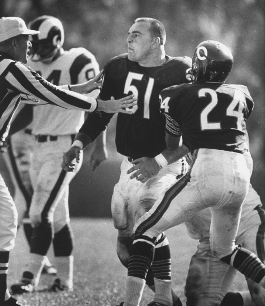 Dick Butkus appears agitated during a game against the Rams after his helmet was ripped off his head -- by the face mask -- following his first pro interception, 1965.