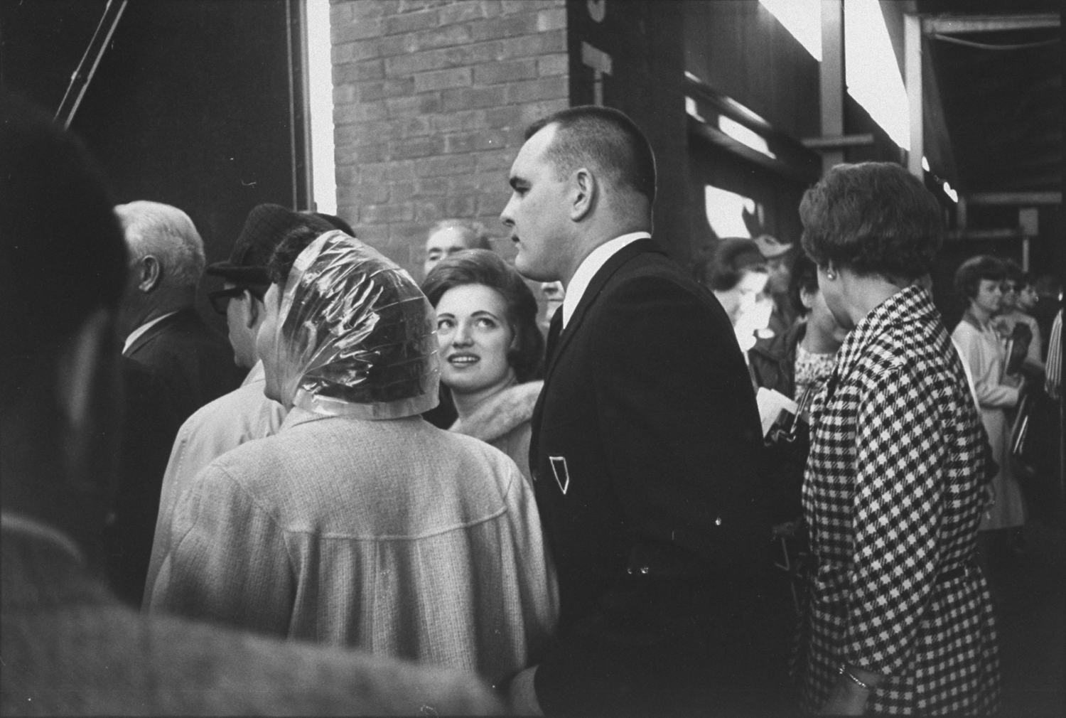 Leaving Wrigley Field after a game, Helen Butkus gazes at her hero. They met in high school, married while Dick was attending the U. of Illinois.