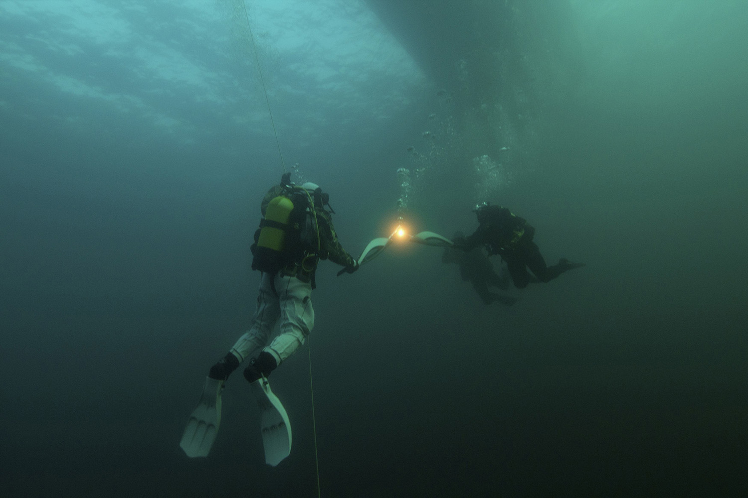 Diving torchbearers are seen during the Sochi 2014 Winter Olympic torch relay underwater Lake Baikal