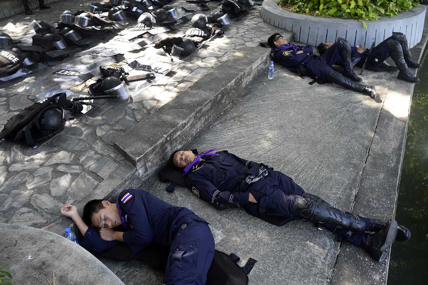 Thai riot police take a nap in Dusit Zoo as they enjoy some free time during a lull in demonstrations in downtown Bangkok