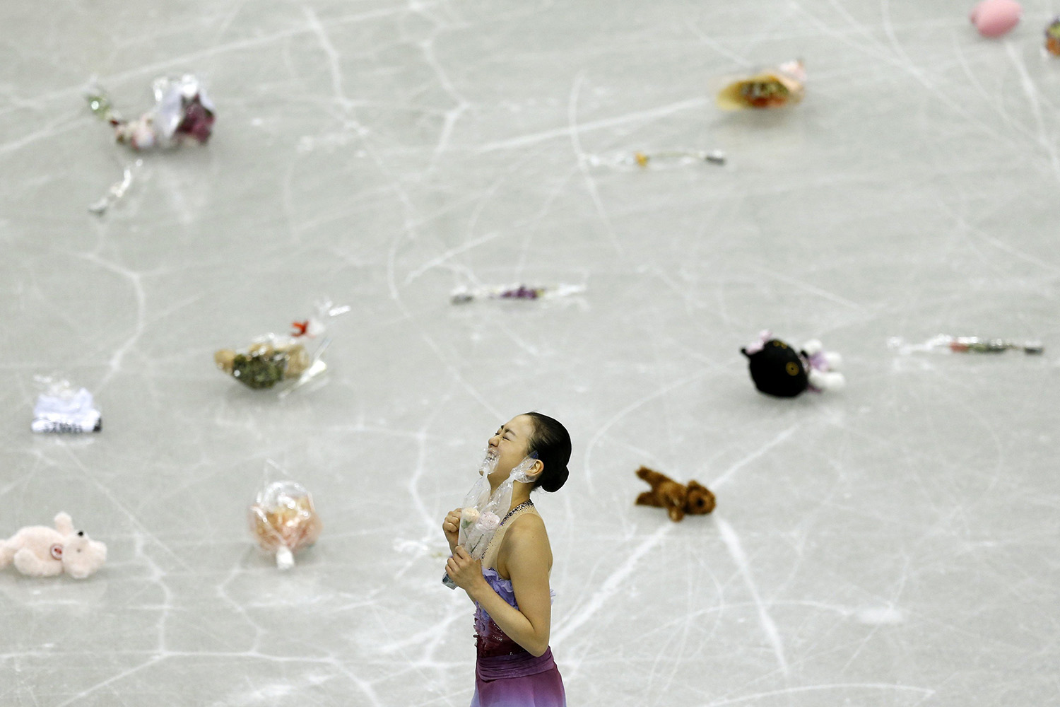 Asada of Japan reacts after performing during women's short programme at ISU Grand Prix of Figure Skating Final in Fukuoka