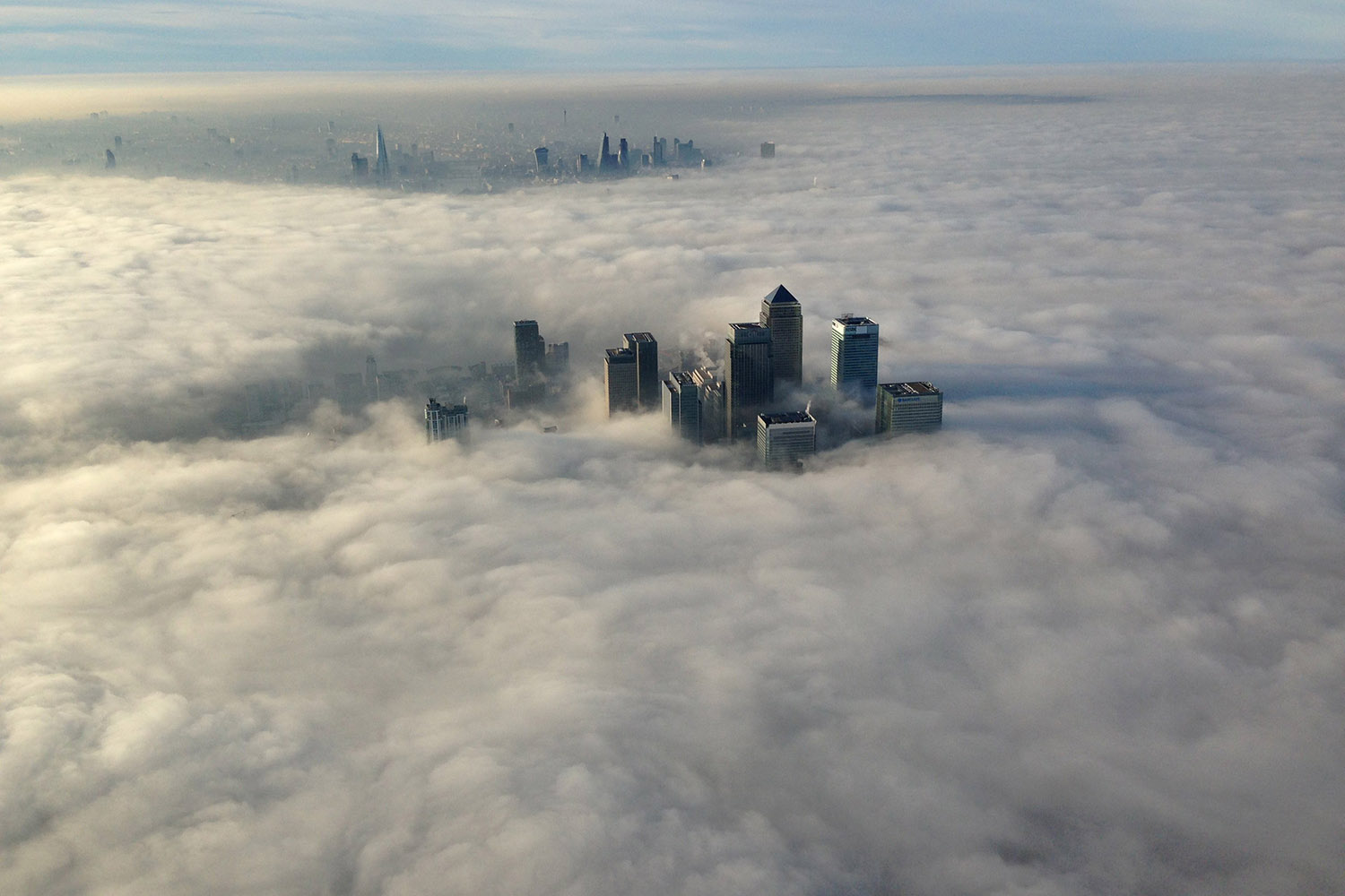 The Canary Wharf business district of east London taken from the Metropolitan Police helicopter is seen during a foggy morning in this photograph received via the Metropolitan Police in London