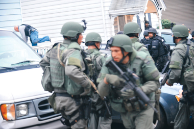6:02.14 p.m.:  Tactical Police Officers converge on the house where 19-year-old Boston Marathon bombing suspect Dzhokhar Tsarnaev was hiding at the time of his in Watertown, Mass.