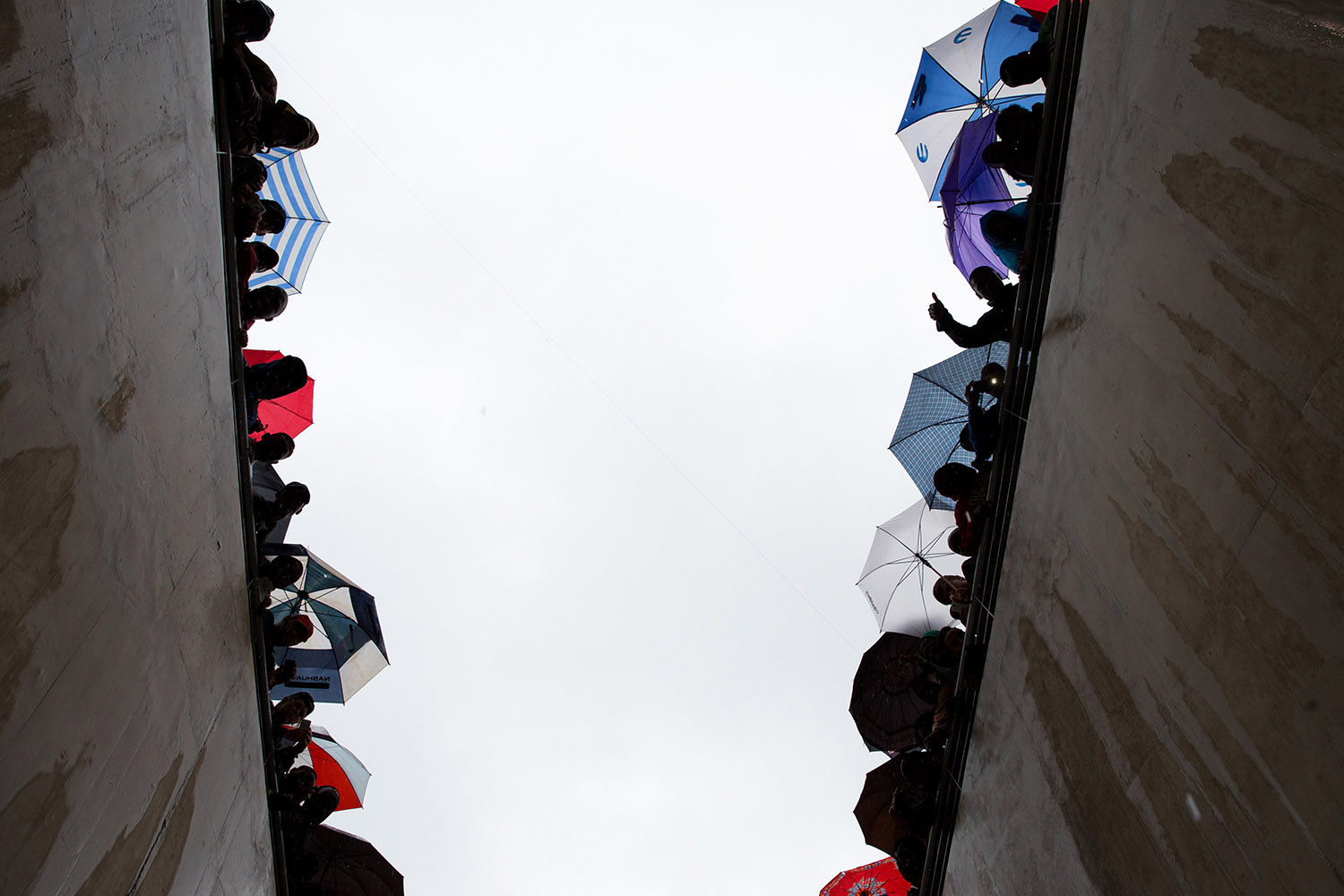 Attendees look down into a stadium entrance at the state memorial service for former South African President Nelson Mandela in Johannesburg.