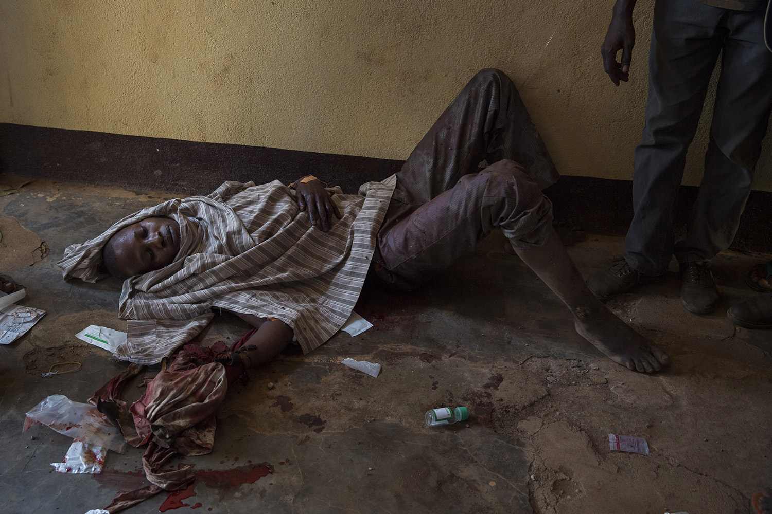 A mulsim man wounded by machete blows is treated in a Ali Babolo mosque in the muslim district of 5Kilo, 58 bodies, including 4 women, were also brought there following several battles launched on early morning by antibalakas. Most of the dead were killed by machete blows.