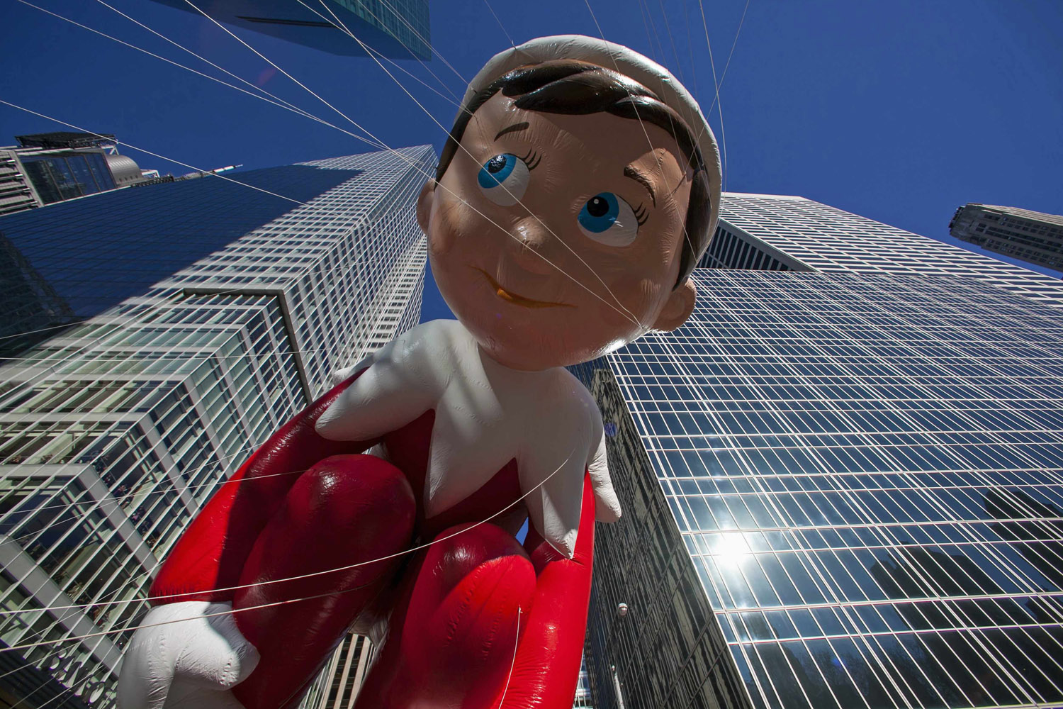 The Elf on the Shelf balloon floats down Sixth Avenue during the 87th Macy's Thanksgiving Day Parade in New York