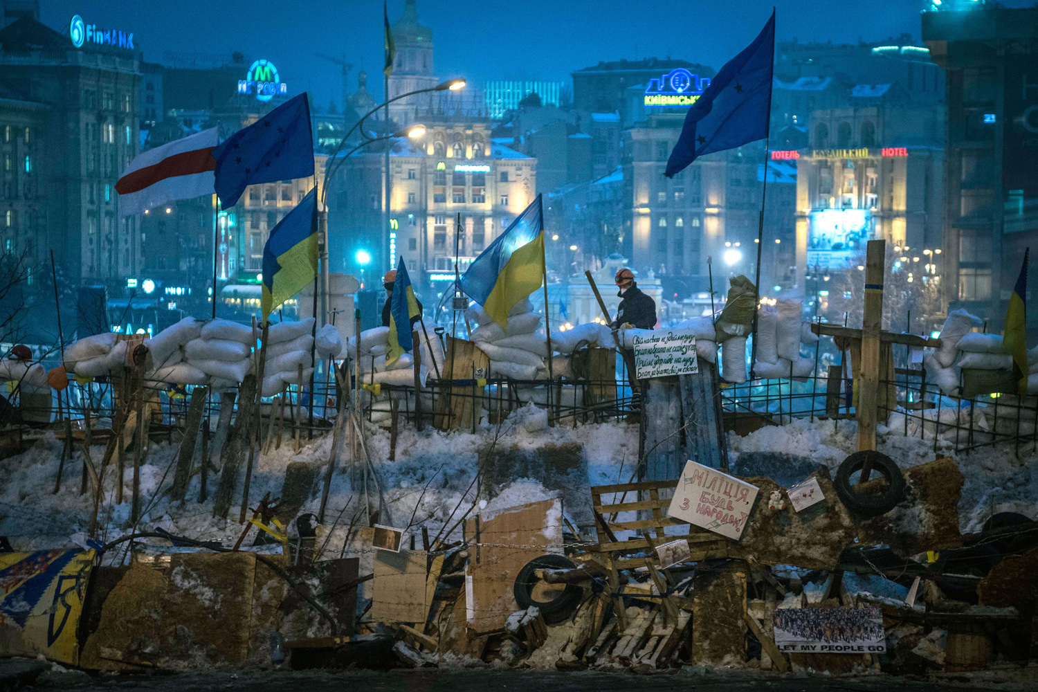 Ukrainian and European Union flags fly over the newly-erected barricades at Independence Square in Kiev, Ukraine.