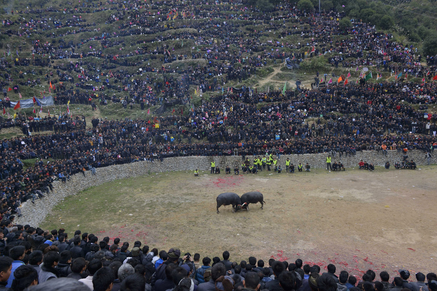 People from neighbouring villages watch a bullfight in Congjiang county