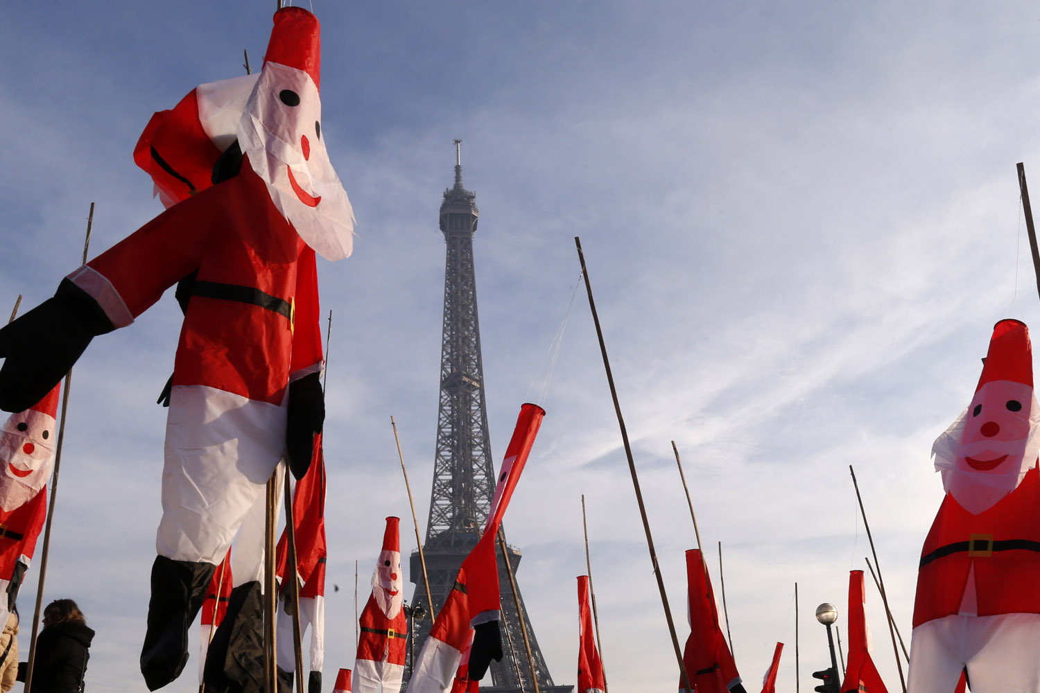 Santa Claus kites float in front of the Eiffel Tower as part of Christmas holiday season preparations in Paris