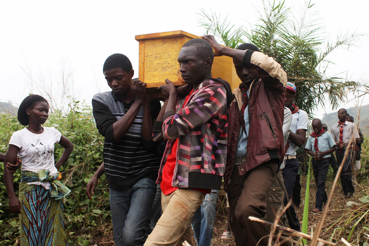 Friends and relatives of Yanguere Richard, 21, carry his remains to the burial grounds in Bangui