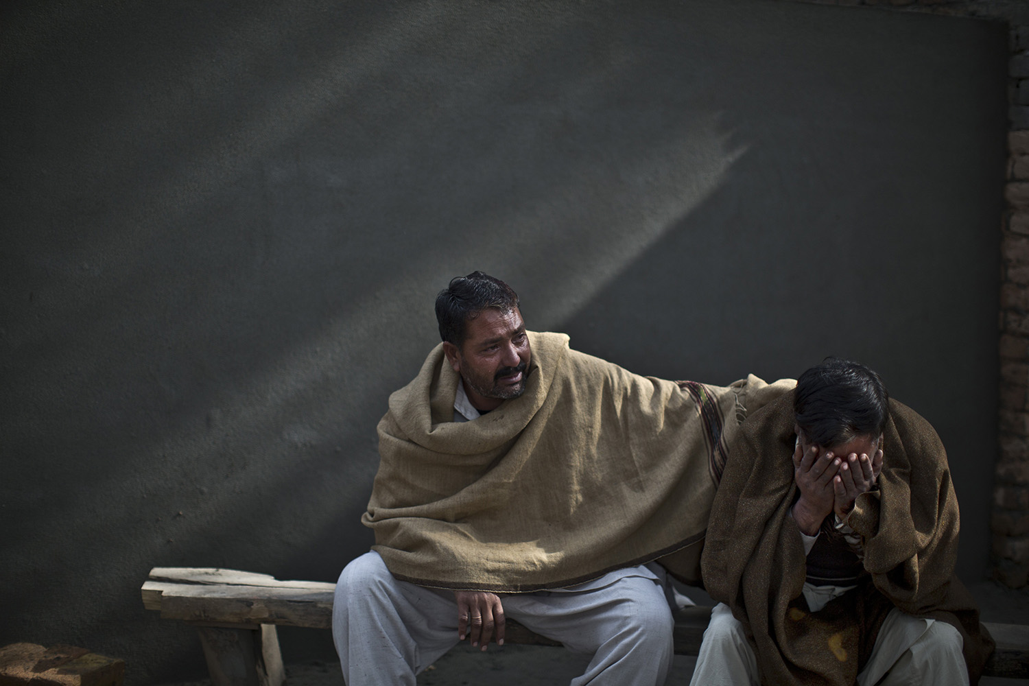 Jan. 20, 2014. Uncles of Pakistani student, Zoubair Latif, 17, who was killed in a suicide bombing, mourn his death while waiting at a hospital to take the body for burial, in Rawalpindi, Pakistan.