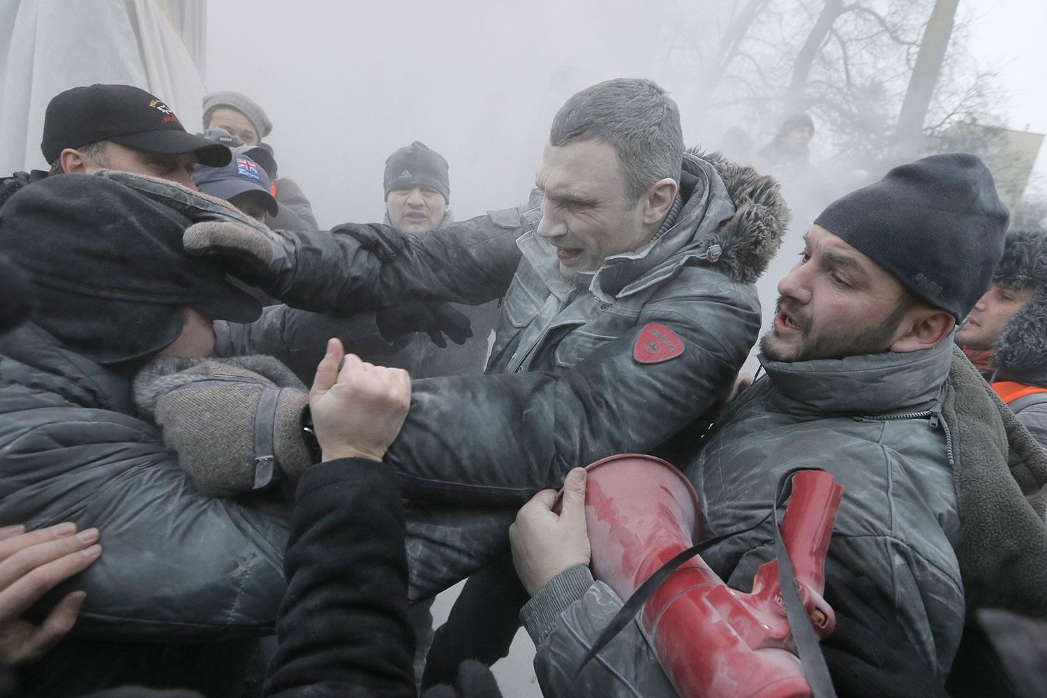 Jan. 19, 2014. Opposition leader and former WBC heavyweight boxing champion Vitali Klitschko, center, is attacked and sprayed with a fire extinguisher as he tries to stop the clashes between police and protesters  in central Kiev, Ukraine.