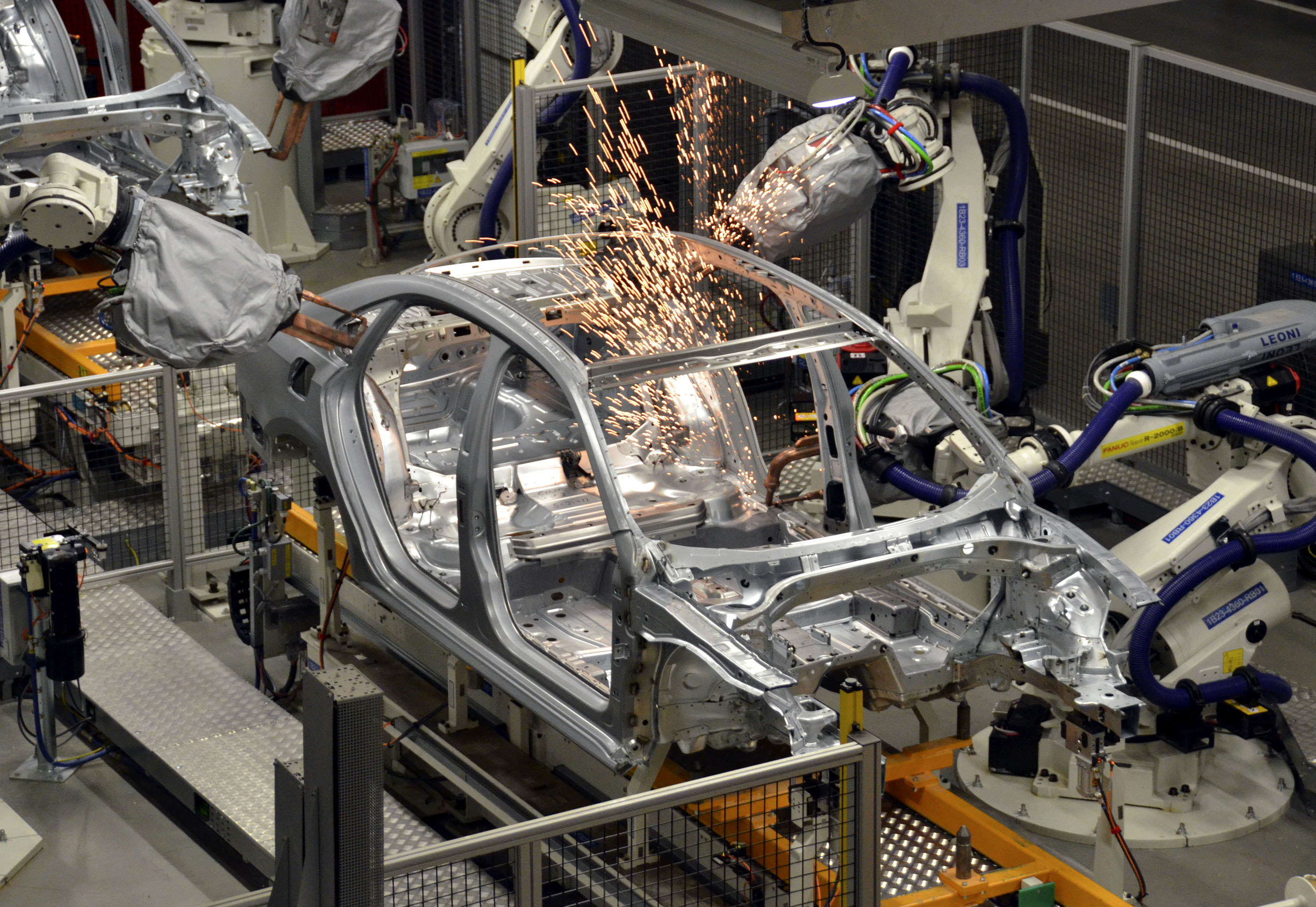 Robots at the Volkswagen Chattanooga plant weld a 2012 VW Passat in the body shop at the plant near Chattanooga, Tennessee, U.S., on Wednesday, June 1, 2011. The plant which has an initial capacity of 125,000 units per year, will build the 2012 Volkswagen Passat for the U.S., Mexico and Canada. Photographer: Mark Elias/Bloomberg (Mark Elias / Bloomberg via Getty Images)