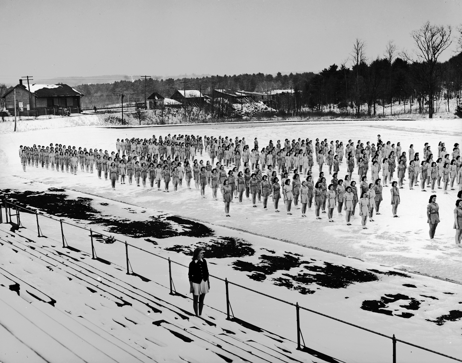 Coeds at the University of New Hampshire perform military drills in freezing weather, 1942.