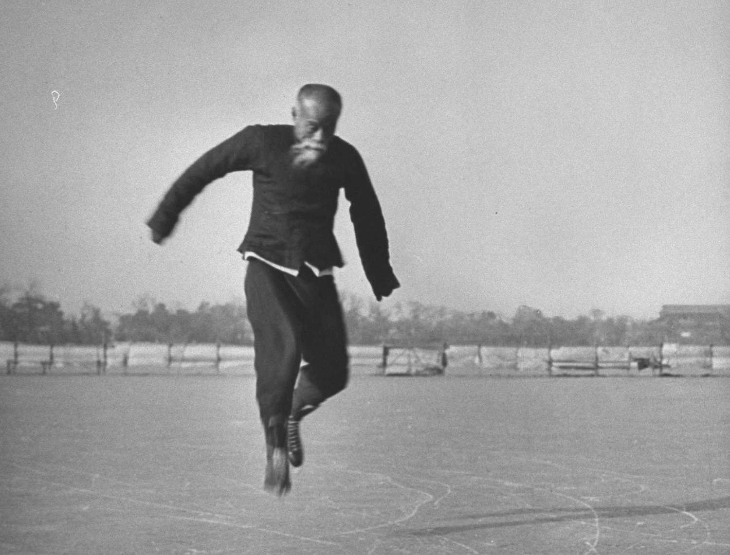 Wu Tang-shen, a 66-year-old avid ice skater in 1946 China, executes a bunny hop maneuver.