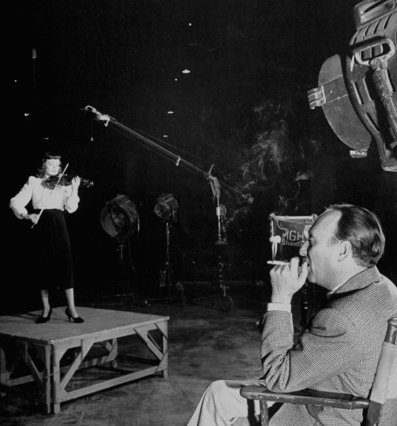 On a deserted sound stage on the M-G-M lot, producer Joseph Pasternak listens as his newest protege, Marcia Van Dyke, plays her violin.